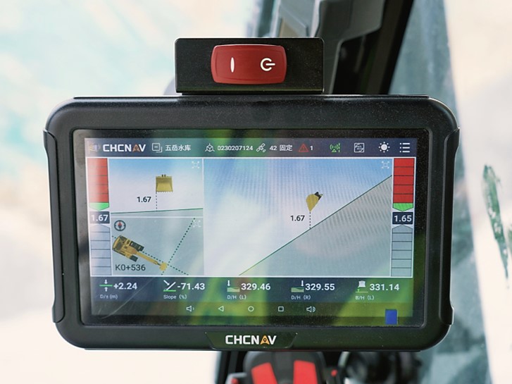 Excavator working on road construction with RTK positioning support.